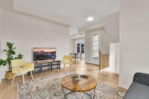 a living room with a couch and a table at Modern Living in Vaughan - Brand New 3BR House in Vaughan