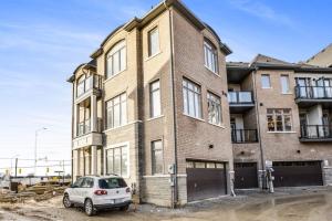 a car parked in front of a brick building at Modern Living in Vaughan - Brand New 3BR House in Vaughan