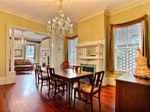 a dining room with a table and chairs at Washington Square Manor in Savannah