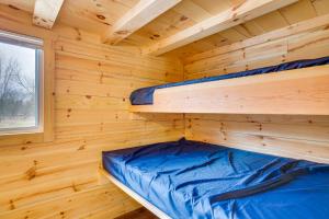 a wooden cabin with two bunk beds in it at Mauston Studio Cabin about 15 Mi to Wisconsin Dells! in Lyndon Station