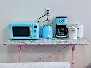 a table with a microwave and a coffee maker on it at Stadium Lofts on Meridian #4 in Indianapolis