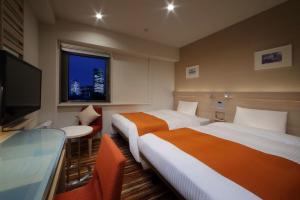 Кровать или кровати в номере Keio Presso Inn Akasaka