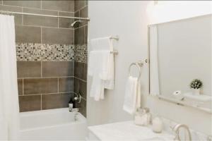 a white bathroom with a tub and a sink at Stadium Lofts on Meridian #2 in Indianapolis +15 photos