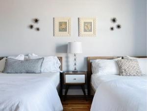 a bedroom with two beds and a table with a lamp at Stadium Lofts on Meridian #2 in Indianapolis