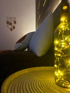 a bottle with lights on top of a bed at Pura Vida Apartment in Catania