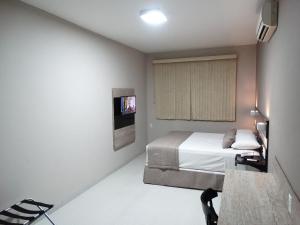 Säng eller sängar i ett rum på Riviera Pantanal Hotel