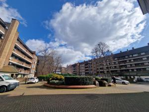 a person walking in a parking lot with buildings at Comfortable 2 bedrooms flat in Oval Central London in London