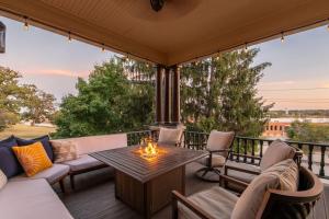a patio with a table and chairs and a fire pit at Lively Mansion of Davenport in Davenport