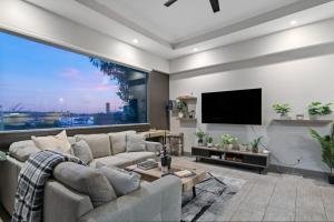 a living room with a couch and a large window at Lively Mansion of Davenport in Davenport