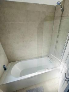 a white bath tub in a bathroom at Suite 1 - Large Private Room near City Centre in Liverpool