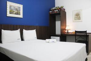 Postel nebo postele na pokoji v ubytování JS Thermas Hotel