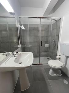 a bathroom with a sink and a shower with a toilet at CASA DO PAÇO NOVO in Castelo de Vide