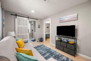 a living room with a flat screen tv on a wall at Lakeside Bliss 2BR, 1BA with All Modern Comforts in Algonac