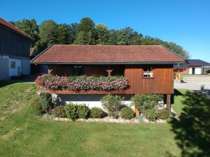 a house with flowers on the side of it at Ferienhaus Breit in Eppenschlag