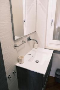 a bathroom with a white sink and a mirror at Elegant Apartment in Santa by PortofinoVacanze in Santa Margherita Ligure +29 photos