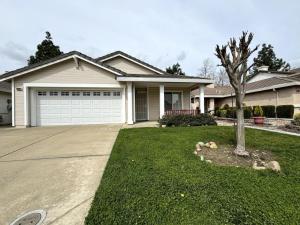 a house with a tree in front of a driveway at King Bed Retreat, Pet-Friendly, Rancho Cordova in Rancho Cordova