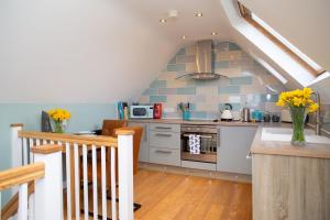a kitchen with a sink and a stove top oven at Vilureef Broad Haven in Broad Haven