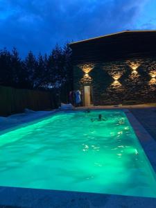 a swimming pool lit up at night at Moserhof in Wahlhausen