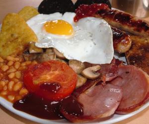 a plate of breakfast food with eggs bacon beans and toast at The Apothecary Guest House in Haworth