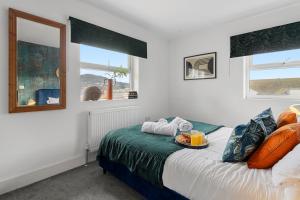 a bedroom with a bed with a tray of food on it at Beachbreeze in Teignmouth