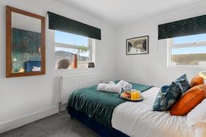 a bedroom with a bed with a tray of food on it at Sea views, Beachbreeze, Pet friendly, Private parking in Teignmouth