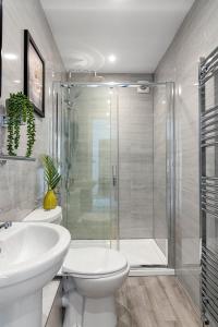 a bathroom with a shower and a toilet and a sink at Sea views, Beachbreeze, Pet friendly, Private parking in Teignmouth