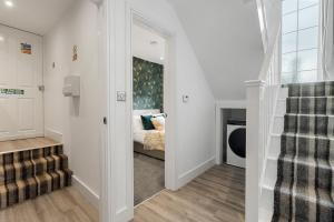 a hallway with a stairway leading to a bedroom at Beachbreeze in Teignmouth