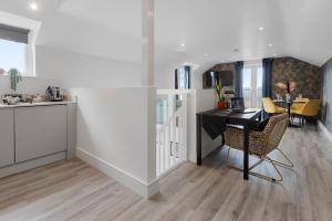 a kitchen and dining room with a table and chairs at Sea views, Beachbreeze, Pet friendly, Private parking in Teignmouth
