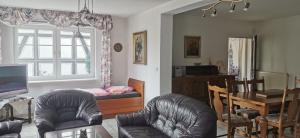 a living room with chairs and a table and a dining room at Landhaus Wohnung in D 63667 Nidda, Gäßchen 8 Erdgeschoss rechts in Nidda