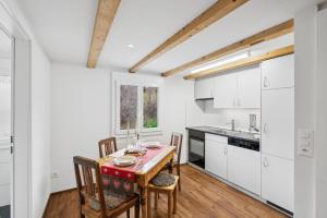 a kitchen and dining room with a table and chairs at Kuschelige Ferienwohnung direkt an der Skipiste in Wildhaus