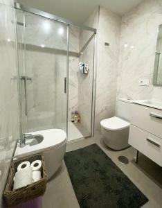 a bathroom with a shower and a toilet and a sink at Sunny Panorama in Torrox