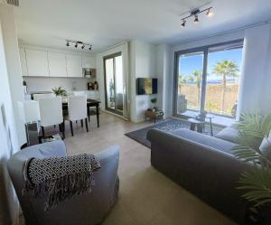 a living room with a couch and a dining room at Sunny Panorama in Torrox