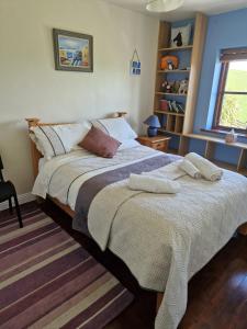a bedroom with a bed with two pillows on it at Drummonds House in Sligo