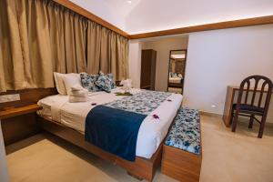 Ein Bett oder Betten in einem Zimmer der Unterkunft Elixir Woods Luxury Resort And Spa, Munnar