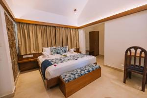 Ein Bett oder Betten in einem Zimmer der Unterkunft Elixir Woods Luxury Resort And Spa, Munnar