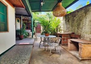 a patio with a table and chairs and a stone wall at Casa Completa "Casa Macondo" 3BD 2BH 9 Personas in Granada