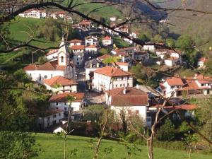 a small village on a hill with white houses at Etxezuria in Valcarlos