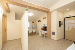 a room with a hallway with a table and chairs at Le Ghiande Guest House in Casal Palocco