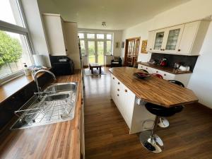 a kitchen with a sink and a counter top at Littlestairs in Shanklin