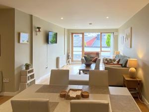een grote woonkamer met een tafel en stoelen bij Apartment 453 - Clifden in Clifden