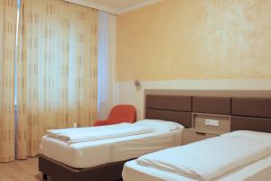 Postel nebo postele na pokoji v ubytování Isar City Hotel