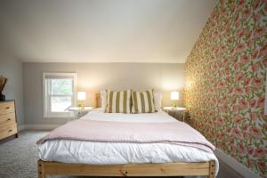 a bedroom with a large bed and two lamps at Modern Boho Bungalow - Near MOA in Saint Paul