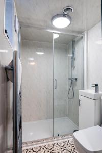 a bathroom with a shower with a glass door at Park Place - 1 Bedroom Apartment in Bristol by Mint Stays in Bristol