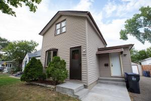 a small white house with a white door at Modern Boho Bungalow - Near MOA in Saint Paul
