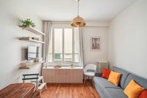 a living room with a couch and a table at Studio near Invalides in Paris
