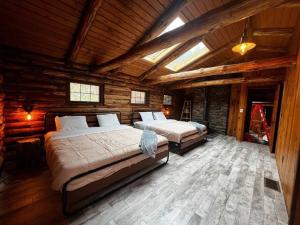 um quarto com 2 camas num chalé de madeira em Woodchuck Sanctuary em Roxbury
