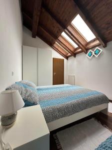 a bedroom with a bed and a table with a lamp at Apartma Popeye in Bovec