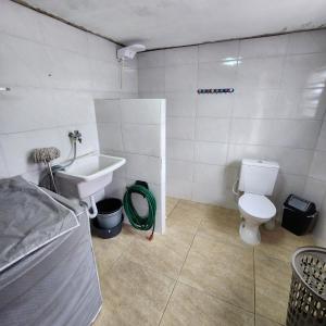 un baño con inodoro y lavabo en Casa com piscina e Wi Fi em Mongagua SP, en Praia Grande