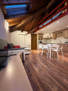 a kitchen and dining room with a table and chairs at Apartma Popeye in Bovec +6 photos