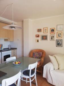 a kitchen and living room with a table and chairs at Kione Vidalmar in Alcossebre +14 photos